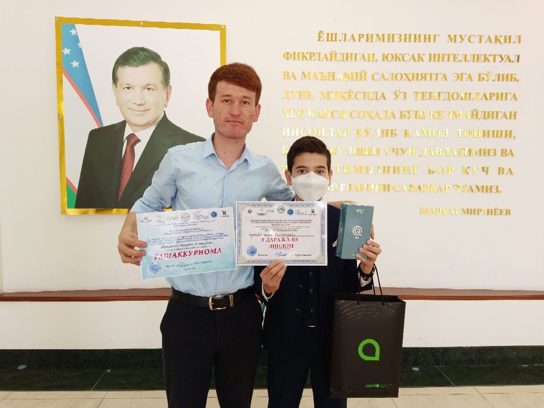 Asadbek's younger brother with his Robot-UZ 2021 diploma